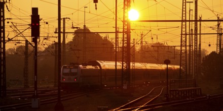 Travelling train at sunrise, Central Station, Dortmund, Ruhr Area, Germany