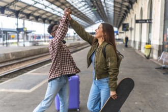 Two young tourists are giving a high five at the train station, excited for their next adventure