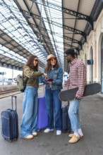 Group of friends waiting at the railway station, displaying passports and tickets while eagerly