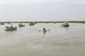 Boats at moorings on River Ore, Orford, Suffolk, England, UK