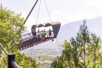 Tourists on a floating viewing platform with a mountain landscape in the background, Botanical