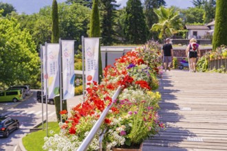 Flowerbeds along a wooden path with flags and walkers, Botanical Garden, The Gardens of