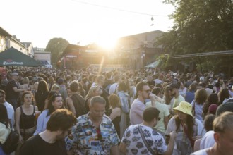 People in front of the bathhouse on the RAW grounds as part of the Fête de la Musique. The music