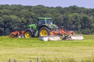 Farmer with tractor mowing a meadow in the Swabian Alb. Merklingen, Baden-Württemberg, Germany