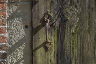Old wooden door with iron fittings, Münsterland, North Rhine-Westphalia, Germany