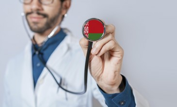Doctor holding stethoscope with Belarus flag. Belarus health and care concept, Belarus flag on