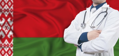 Belarus healthcare concept. Male doctor on Belarus flag. Doctor with crossed arms on Belarus flag