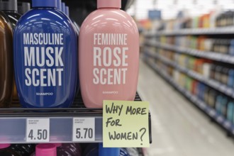 Pink tax concept shpwing two gendered shampoo bottles priced differently. Blue masculine and pink
