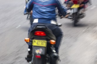 Man riding a motorcycle, Riding at high speed, Photo with motion blur, City of Quito, Pichincha