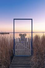 View along a footbridge through a door frame to the Steinhuder Meer in the evening light, Great