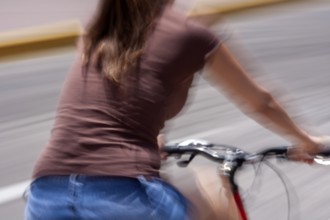 Woman riding a bicycle, Photo with motion blur, City of Quito, Pichincha province, Ecuador, South
