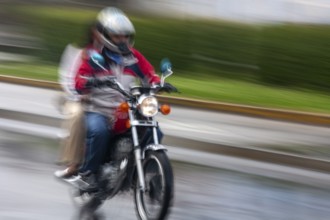 Man riding a motorcycle, Riding at high speed, Photo with motion blur, City of Quito, Pichincha