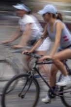 Women riding on bicycles, Photo with motion blur, City of Quito, Pichincha province, Ecuador, South