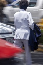 Woman crossing a street, Photo with motion blur, City of Quito, Pichincha province, Ecuador, South