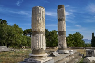 Two Doric columns in the middle of an ancient ruined landscape, Ionian Asclepion temple, Asclepion,