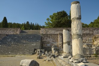 Ruins with broken columns and stone steps under a blue sky, Asklepios Temple, Asklipion,
