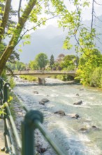 Scenic view of a river with bridge and trees in the background, Merano, Italy