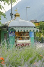 A pretty ice cream shop with a traditional roof, surrounded by lavender and summery nature, Merano,