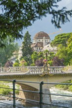 Historic building and bridge with trees in the foreground, Merano, Italy