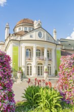 Baroque building with elaborate floral decorations and clear sky in the background, Merano, Italy