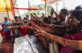 Devotees throng to have food as they arrives to visit Kamakhya Temple during Ambubachi Mela, in