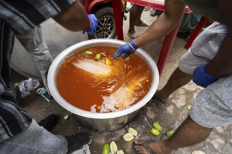 Volunteers makes Sarbat to offer devotees during Ambubachi Mela, in Guwahati, India on June 22,