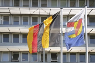 Three flags at the job centre, modern building with window, national flag, Baden-Württemberg state