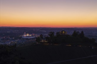 Evening atmosphere with chapel and city lights, silhouette of the vineyards at sunset, grave