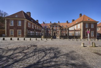 Episcopal Vicariate General, vicariate, brick building, bollards, cobblestone pavement, blue
