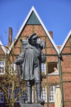 Kiepenkerl monument, bronze sculpture, brick architecture, depth of field, blue cloudless sky,