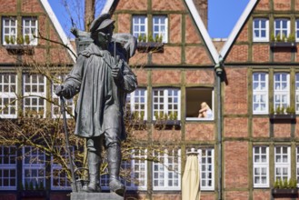Kiepenkerl monument, bronze sculpture, brick architecture, facade, window, depth of field, blue