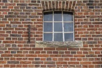 A small, simple window with a round arch in a brick wall, stable window, Legden, Asbeck,