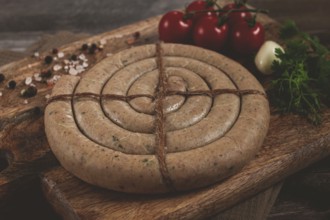 Raw spiral sausages, on a wooden board, top view, no people