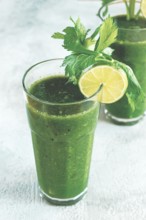 Glass with green smoothie, celery and spinach, apple and kiwi, cucumber, vegetable smoothie,