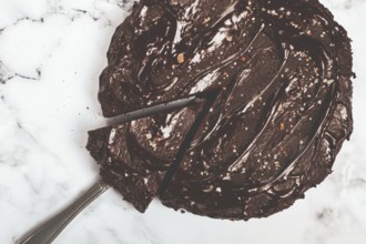 Chocolate cake, round cake, on a marble light table, top view, homemade cakes, no people