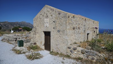 Chapel Agios Nikolaos, Old stone house in Mediterranean landscape with clear blue sky in the