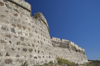 Close-up of massive stone wall building with clear blue sky, Antimacheia, Medieval Fortress, St