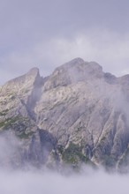 Large rocks rise majestically into the sky in the mist, Dolomites, South Tyrol, Dolomites, Italy