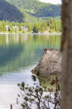 Lake with rocks in the foreground, mountainous landscape in the background, Pragser Wildsee, South