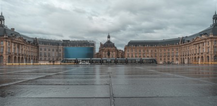 The stock exchange square in bordeaux, france, showcases its elegant architecture reflected on the