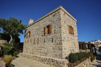 Rustic stone house with manicured garden and clear skies, Kefalos, Kos, Dodecanese, Greek Islands,