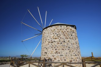Stone windmill with wooden railings under a blue sky, Kefalos, Kos, Dodecanese, Greek Islands,