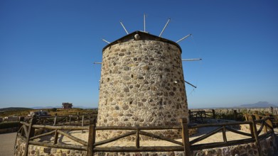 Stone windmill under a wide blue sky in a rural setting, Kefalos, Kos, Dodecanese, Greek Islands,