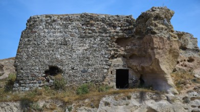 Ruins of a castle, Dilapidated stone ruins with exposed walls, surrounded by natural landscape