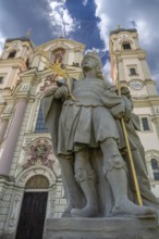 Sculpture of the church patron St Theodore in front of the east tower of the baroque Basilica of St