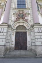 Side entrance portal of the east tower of the baroque Basilica of St Alexander and Theodor,