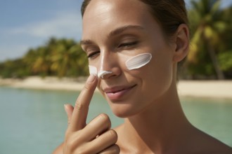 Woman applying sunscreen on her nose. Close-up beach portrait capturing sun care and summer