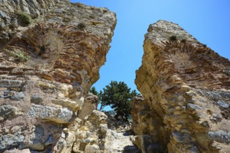 Two massive ancient stone arches open to a clear blue sky, Abandoned Village, Lost Place, Pyli,