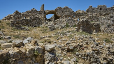 A vast field of ruins with brick arches under a bright blue sky, Abandoned Village, Lost Place,