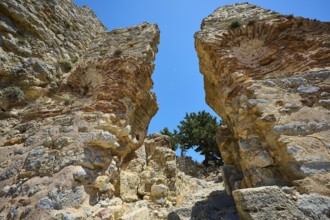 Two large ancient stone arches stand monumental against the blue sky, Abandoned Village, Lost